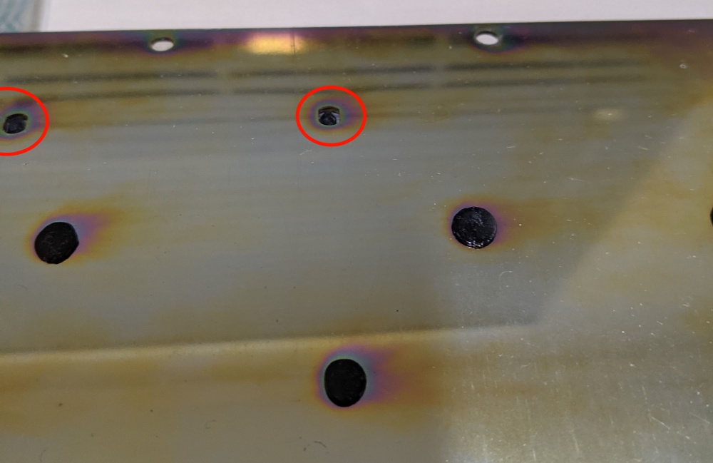 Two broken plastic rivets