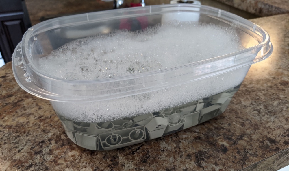 Keycaps soaking in soapy water